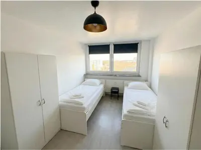 Ein Bett oder Betten in einem Zimmer der Unterkunft L21-Apartment Dortmund, 2 Zimmer, 4 Betten, Standardisierte Ausstattung, ideal für Reisende, Pendler, Familien