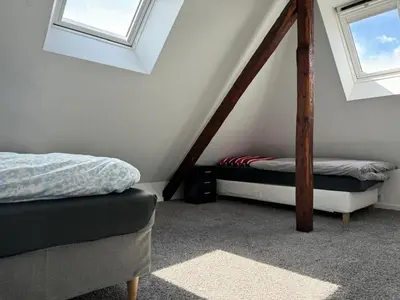 Ein Bett oder Betten in einem Zimmer der Unterkunft Nathanael Ferienwohnung mit Küche, WLAN & 4 Schlafzimmern