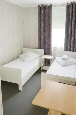 Ein Bett oder Betten in einem Zimmer der Unterkunft Artur Hotel