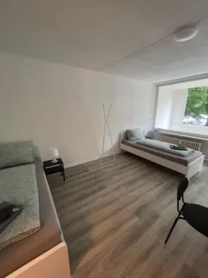 Ein Bett oder Betten in einem Zimmer der Unterkunft Gemütliches Apartment in Wuppertal Ronsdorf mit Balkon