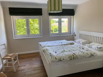 Ein Bett oder Betten in einem Zimmer der Unterkunft Baumberger Blick