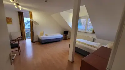 Ein Bett oder Betten in einem Zimmer der Unterkunft Appartementhaus Sudberg