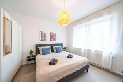 Ein Bett oder Betten in einem Zimmer der Unterkunft 6P Zentrale Suite mit Balkon & Parkplatz