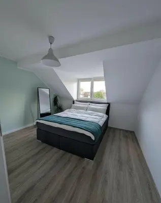 Ein Bett oder Betten in einem Zimmer der Unterkunft Traumwohnung über den Dächern Rüttenscheids
