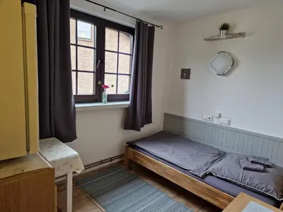 Ein Bett oder Betten in einem Zimmer der Unterkunft Pension Moers am Geleucht
