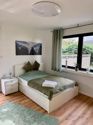 Ein Bett oder Betten in einem Zimmer der Unterkunft Grüne Oase in Stadtnähe