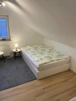 Ein Bett oder Betten in einem Zimmer der Unterkunft Gemütliche Dachgeschoss Wohnung