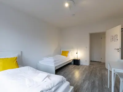 Ein Bett oder Betten in einem Zimmer der Unterkunft BudgetRoom Modernes Apartment mit 3 Schlafzimmern