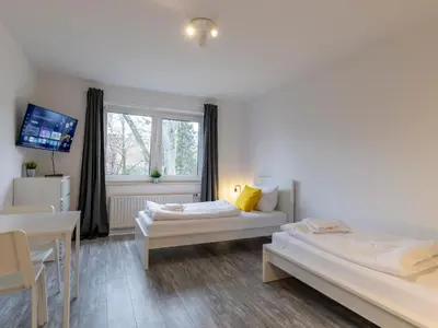 Ein Bett oder Betten in einem Zimmer der Unterkunft BudgetRoom Modernes Apartment mit 3 Schlafzimmern