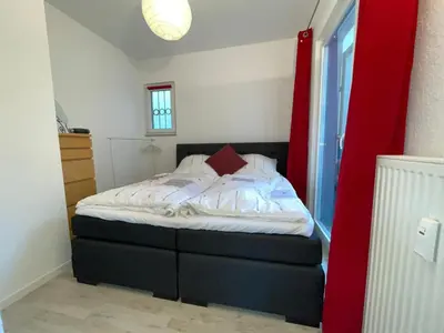 Ein Bett oder Betten in einem Zimmer der Unterkunft Rundes Bungalow mit guten Anbindungen