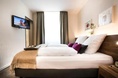 Ein Bett oder Betten in einem Zimmer der Unterkunft Alexianer Hotel am Wasserturm