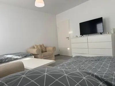 Ein Bett oder Betten in einem Zimmer der Unterkunft Modernes City Apartment 2 Min zum HBF Mülheim