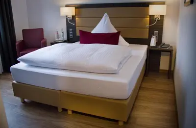 Ein Bett oder Betten in einem Zimmer der Unterkunft Hotel Restaurant Passmann