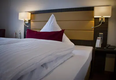 Ein Bett oder Betten in einem Zimmer der Unterkunft Hotel Restaurant Passmann