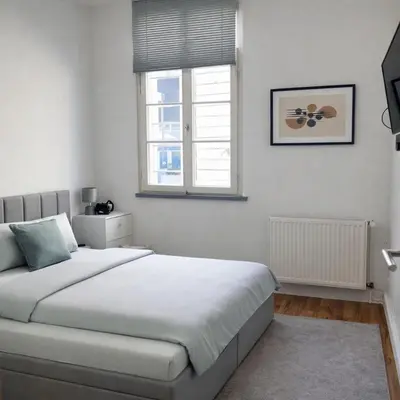 Ein Bett oder Betten in einem Zimmer der Unterkunft Zum Postwagen Apartments