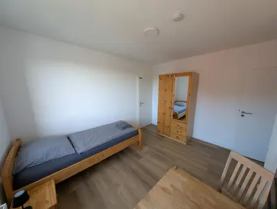 Ein Bett oder Betten in einem Zimmer der Unterkunft Ferienwohnung Gästehaus Bauer 1