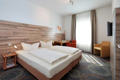 Ein Bett oder Betten in einem Zimmer der Unterkunft Petul Apart Hotel Residenz