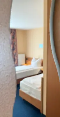 Ein Bett oder Betten in einem Zimmer der Unterkunft TM Apart Hotel Essen