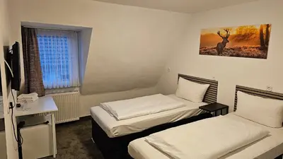 Ein Bett oder Betten in einem Zimmer der Unterkunft Hotel Kölner Hof