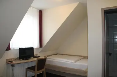 Ein Bett oder Betten in einem Zimmer der Unterkunft Hotel Stadt Kamen