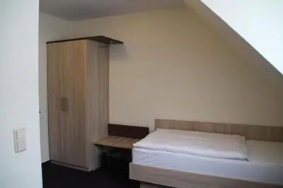 Ein Bett oder Betten in einem Zimmer der Unterkunft Hotel Stadt Kamen