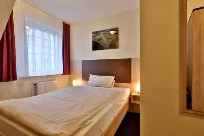 Ein Bett oder Betten in einem Zimmer der Unterkunft Hotel Stadt Kamen