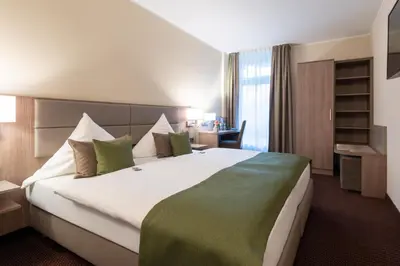 Ein Bett oder Betten in einem Zimmer der Unterkunft Hotel im Park