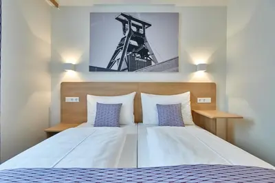 Ein Bett oder Betten in einem Zimmer der Unterkunft McDreams Hotel Essen