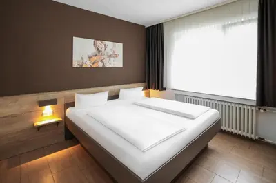 Ein Bett oder Betten in einem Zimmer der Unterkunft Hotel Frohnhauser Hof