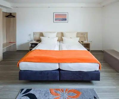 Ein Bett oder Betten in einem Zimmer der Unterkunft Hotel Moerser Hof