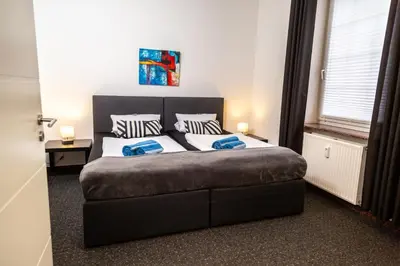Ein Bett oder Betten in einem Zimmer der Unterkunft Aparthotel Menden
