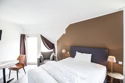 Ein Bett oder Betten in einem Zimmer der Unterkunft Wald & Golfhotel Lottental