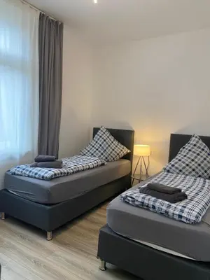Ein Bett oder Betten in einem Zimmer der Unterkunft House-In Apartments Essen - Free Parking - WiFi - Kitchen