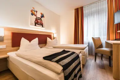 Ein Bett oder Betten in einem Zimmer der Unterkunft Hotel am Stadtpark