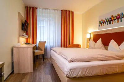Ein Bett oder Betten in einem Zimmer der Unterkunft Hotel am Stadtpark