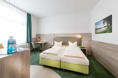 Ein Bett oder Betten in einem Zimmer der Unterkunft Hotel Reichshof garni