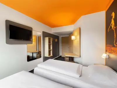 Ein Bett oder Betten in einem Zimmer der Unterkunft B&B Hotel Essen-City