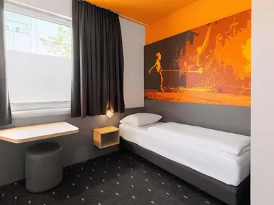 Ein Bett oder Betten in einem Zimmer der Unterkunft B&B Hotel Essen-City