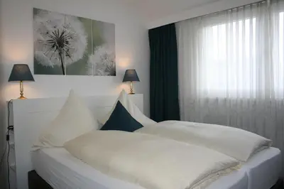 Ein Bett oder Betten in einem Zimmer der Unterkunft AKZENT Hotel Merfelder Hof