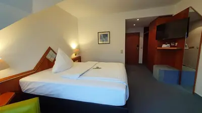 Ein Bett oder Betten in einem Zimmer der Unterkunft AKZENT Hotel Merfelder Hof