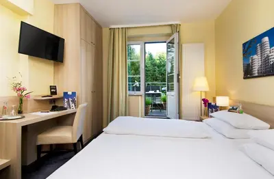 Ein Bett oder Betten in einem Zimmer der Unterkunft Hotel am Hofgarten