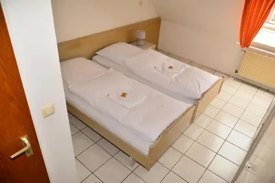 Ein Bett oder Betten in einem Zimmer der Unterkunft Hotel Wilhelmshöhe