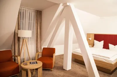 Ein Bett oder Betten in einem Zimmer der Unterkunft Hotel Specht by Trotmannia