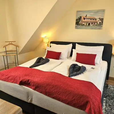 Ein Bett oder Betten in einem Zimmer der Unterkunft Haus Scheuten Hotel