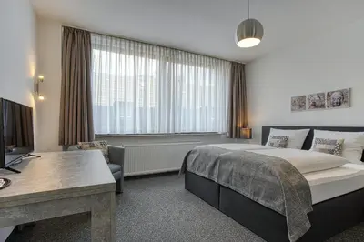 Ein Bett oder Betten in einem Zimmer der Unterkunft Hotel Carlton