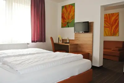 Ein Bett oder Betten in einem Zimmer der Unterkunft Hotel Art-Ambiente