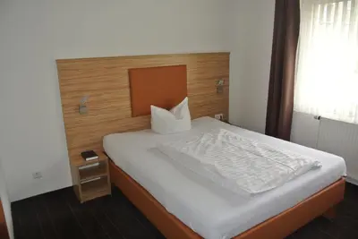 Ein Bett oder Betten in einem Zimmer der Unterkunft Hotel Art-Ambiente