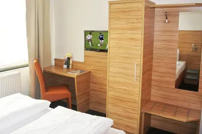 Ein Bett oder Betten in einem Zimmer der Unterkunft Hotel Art-Ambiente