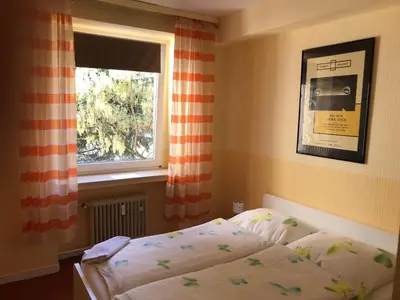 Ein Bett oder Betten in einem Zimmer der Unterkunft Gästehaus Grupello