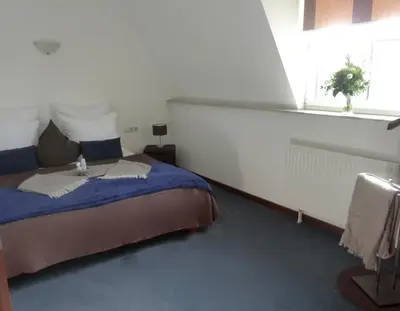 Ein Bett oder Betten in einem Zimmer der Unterkunft Hotel Zum Bügeleisen